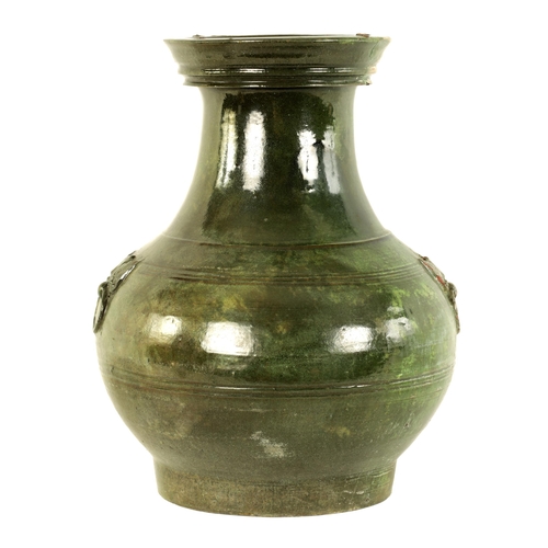 182 - A CHINESE HAN DYNASTY GREEN GLAZED POTTERY HU VASE with masked side mounts and ringed decoration - s... 