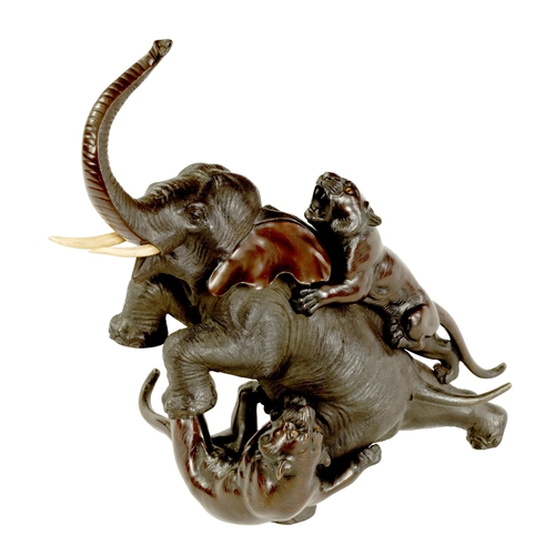 188 - A JAPANESE MEIJI PERIOD PATINATED BRONZE ANIMALIER GROUP depicting a pair of tigers and an elephant ... 