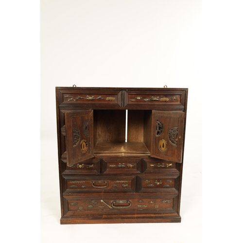 190 - A JAPANESE MEIJI PERIOD STAINED WOOD COLLECTOR'S CABINET fitted with gilt bronze menuki, comprising ... 