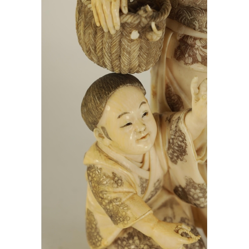 194 - A LARGE JAPANESE MEIJI PERIOD CARVED IVORY FIGURE GROUP depicting a flower seller with child - signe... 