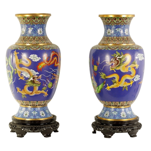 196 - A LARGE PAIR OF CHINESE CLOISONNÉ VASES having brightly coloured enamel decoration depicting dragons... 