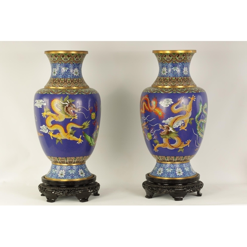 196 - A LARGE PAIR OF CHINESE CLOISONNÉ VASES having brightly coloured enamel decoration depicting dragons... 