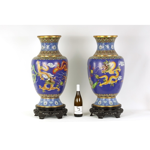 196 - A LARGE PAIR OF CHINESE CLOISONNÉ VASES having brightly coloured enamel decoration depicting dragons... 