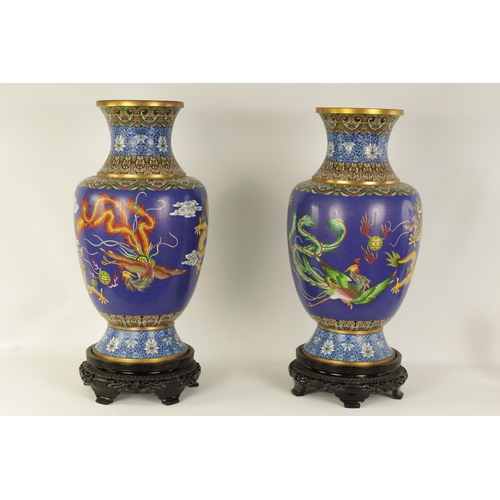 196 - A LARGE PAIR OF CHINESE CLOISONNÉ VASES having brightly coloured enamel decoration depicting dragons... 