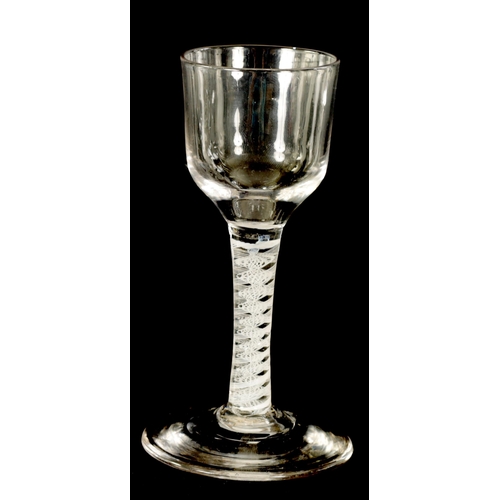 2 - A GEORGIAN WINE GLASS with ogee bowl on a multi-spiral white opaque-twist stem enclosing a centre ga... 