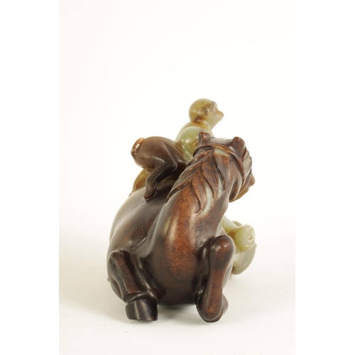 200 - AN EARLY CHINESE CARVED RUSSET JADE SCULPTURE OF A RECUMBENT HORSE AND THREE MONKEYS finely carved a... 