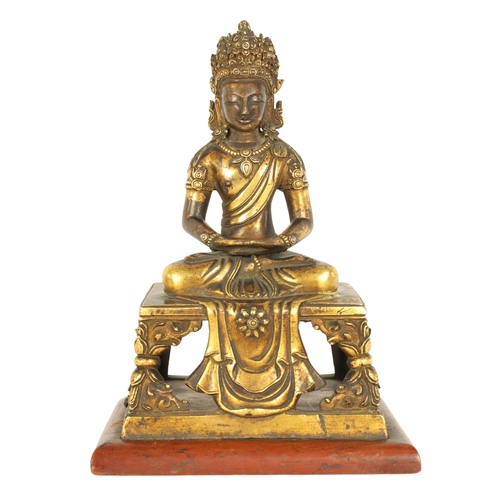 203 - AN EARLY GILT BRONZE TIBETAN BUDDHA DEPICTING AKSHOBHYA seated on a tapered plinth and wood base. (1... 