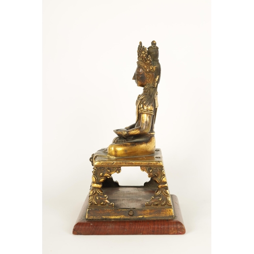 203 - AN EARLY GILT BRONZE TIBETAN BUDDHA DEPICTING AKSHOBHYA seated on a tapered plinth and wood base. (1... 