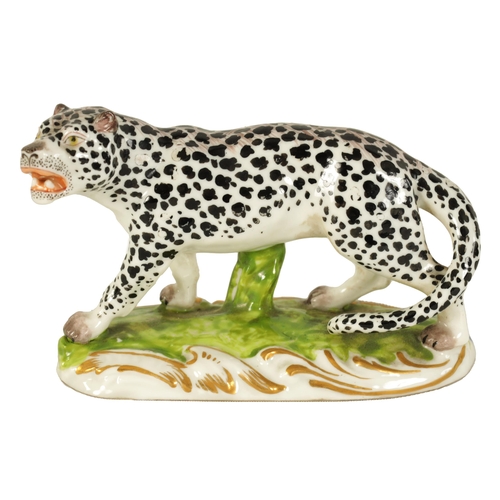 30 - A 19TH CENTURY STAFFORDSHIRE FIGURE OF A LEOPARD mounted on a naturalistic base with gilt decoration... 