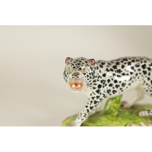 30 - A 19TH CENTURY STAFFORDSHIRE FIGURE OF A LEOPARD mounted on a naturalistic base with gilt decoration... 