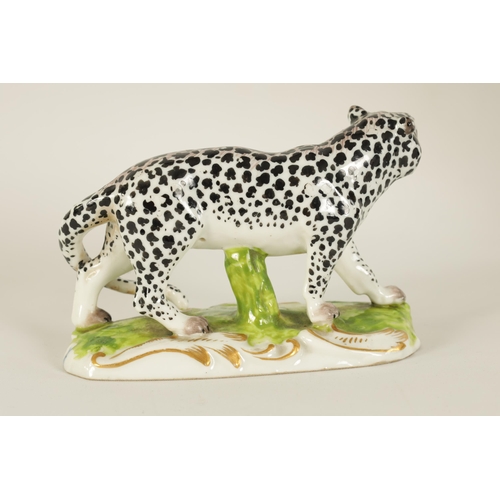 30 - A 19TH CENTURY STAFFORDSHIRE FIGURE OF A LEOPARD mounted on a naturalistic base with gilt decoration... 