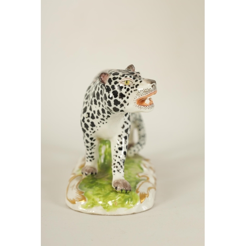 30 - A 19TH CENTURY STAFFORDSHIRE FIGURE OF A LEOPARD mounted on a naturalistic base with gilt decoration... 