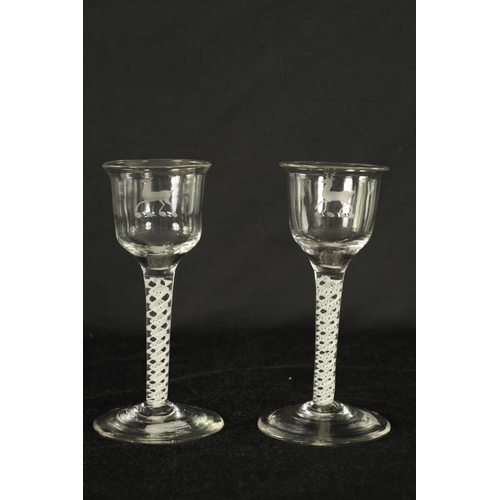 5 - A PAIR OF GEORGIAN ARMORIAL WINE GLASSES OF GENEROUS SIZE the ogee bowls with everted rims and engra... 