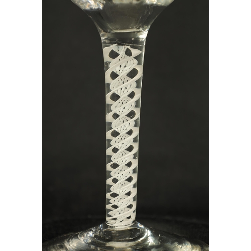 5 - A PAIR OF GEORGIAN ARMORIAL WINE GLASSES OF GENEROUS SIZE the ogee bowls with everted rims and engra... 