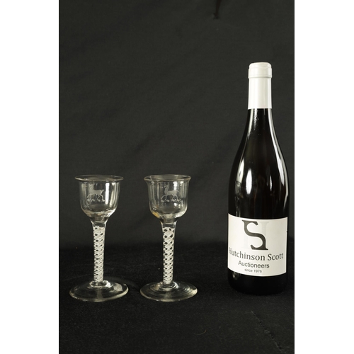 5 - A PAIR OF GEORGIAN ARMORIAL WINE GLASSES OF GENEROUS SIZE the ogee bowls with everted rims and engra... 