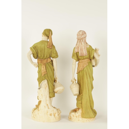 53 - A LARGE PAIR OF LATE 19TH/EARLY 20TH CENTURY ROYAL DUX STANDING FIGURES modelled depicting Eastern W... 