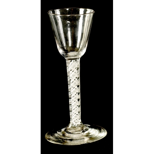 6 - A GEORGIAN WINE GLASS with flared bowl and white opaque multi-spiral twist stem enclosing a pair of ... 