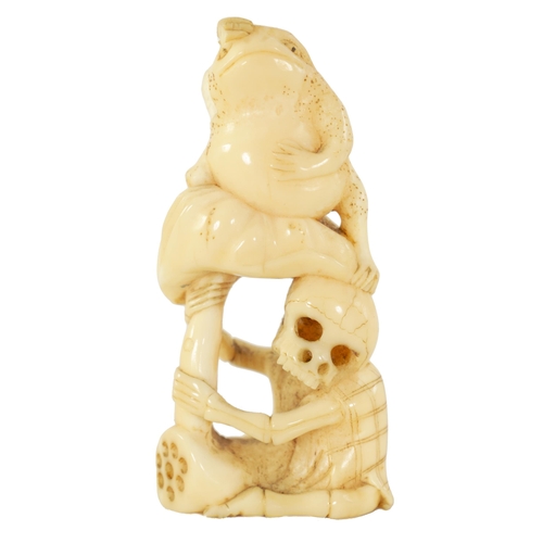 64 - A JAPANESE MEIJI PERIOD CARVED IVORY NETSUKE depicting a frog sat on a skeleton (A.F.). (6.5cm high ... 