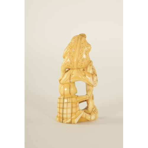 64 - A JAPANESE MEIJI PERIOD CARVED IVORY NETSUKE depicting a frog sat on a skeleton (A.F.). (6.5cm high ... 