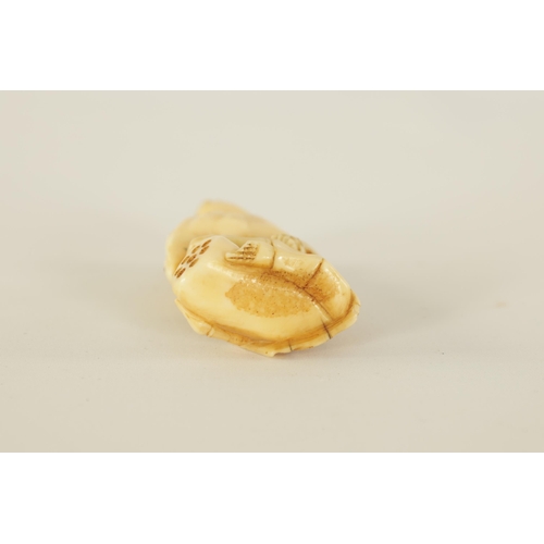 64 - A JAPANESE MEIJI PERIOD CARVED IVORY NETSUKE depicting a frog sat on a skeleton (A.F.). (6.5cm high ... 