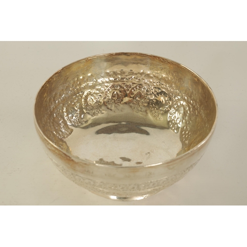 67 - AN EARLY 20TH CENTURY BURMESE SILVER BOWL with foliate engraved and embossed decoration, makers stam... 