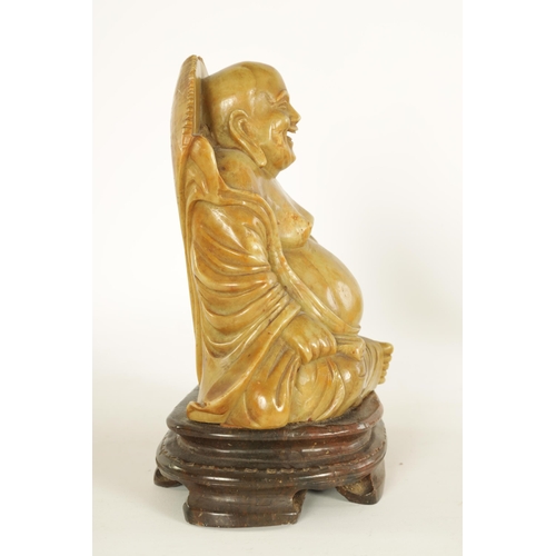 74 - A CHINESE CARVED SOAPSTONE SCULPTURE modelled as a seated Buddha on moulded plinth base. (20.5cm hig... 