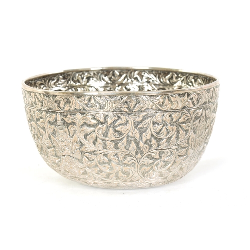 76 - A LATE 19TH CENTURY INDIAN SILVER BOWL with repousse work decoration of figures amongst scrolling le... 