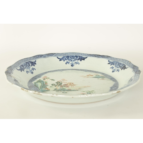 79 - AN 18TH CENTURY CHINESE BLUE AND WHITE SCALLOP EDGE DISH with hatched floral panelled border and inn... 