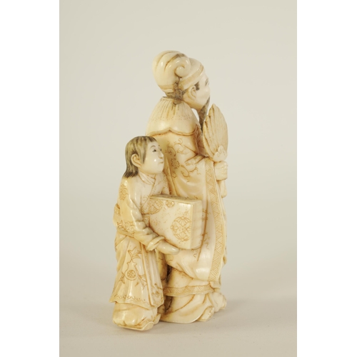 86 - A 19TH CENTURY CHINESE CARVED IVORY FIGURE GROUP depicting a scholar and child. (9cm high)