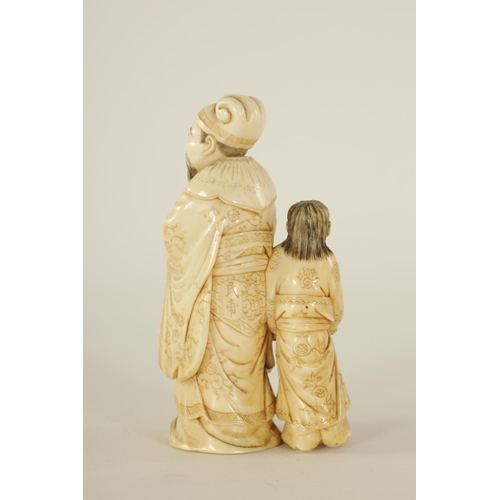 86 - A 19TH CENTURY CHINESE CARVED IVORY FIGURE GROUP depicting a scholar and child. (9cm high)