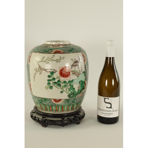 91 - A 19TH CENTURY CHINESE FAMILLE VERTE GINGER JAR ON STAND with panelled floral decoration depiciting ... 