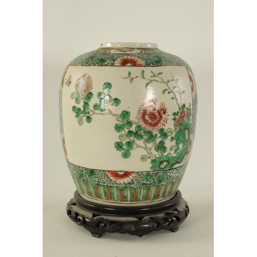 91 - A 19TH CENTURY CHINESE FAMILLE VERTE GINGER JAR ON STAND with panelled floral decoration depiciting ... 