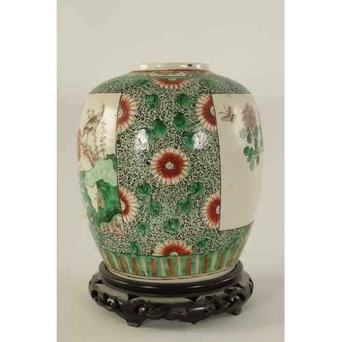 91 - A 19TH CENTURY CHINESE FAMILLE VERTE GINGER JAR ON STAND with panelled floral decoration depiciting ... 