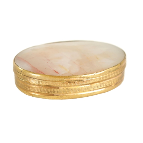 228 - AN EARLY 19TH CENTURY AGATE AND GILT BRASS PILL BOX of oval form with slightly domed agate panels an... 