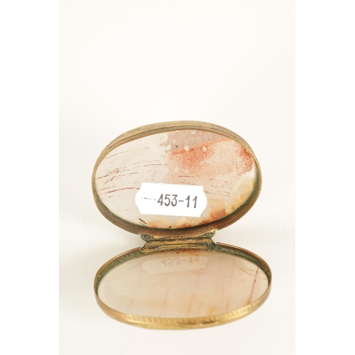 228 - AN EARLY 19TH CENTURY AGATE AND GILT BRASS PILL BOX of oval form with slightly domed agate panels an... 