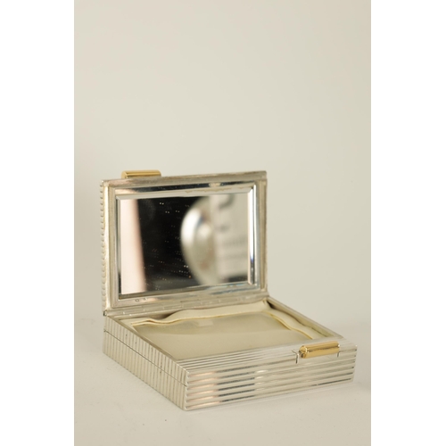 230 - CARTIER, PARIS A MID 20TH CENTURY FRENCH SILVER AND GOLD MOUNTED LADIES POWDER COMPACT the ribbed bo... 