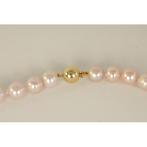 236 - A LARGE STRING OF PINK FRESH WATER PEARLS with 9ct gold clasp (86cm long)