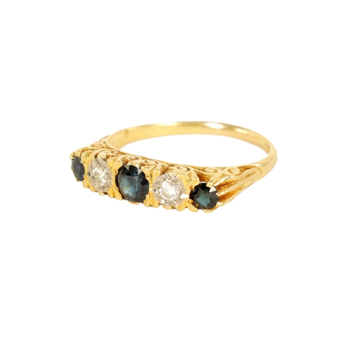 238 - AN 18CT GOLD FIVE STONE DIAMOND AND SAPPHIRE RING with pierced scroll engraved mount, early 20th cen... 