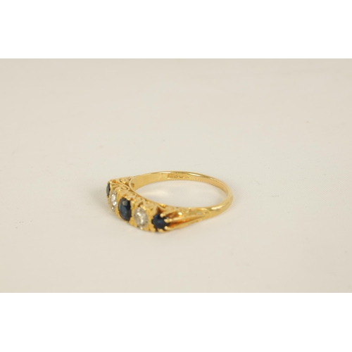 238 - AN 18CT GOLD FIVE STONE DIAMOND AND SAPPHIRE RING with pierced scroll engraved mount, early 20th cen... 