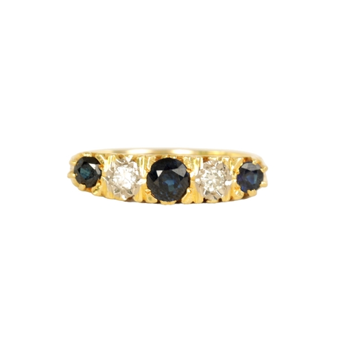 238 - AN 18CT GOLD FIVE STONE DIAMOND AND SAPPHIRE RING with pierced scroll engraved mount, early 20th cen... 