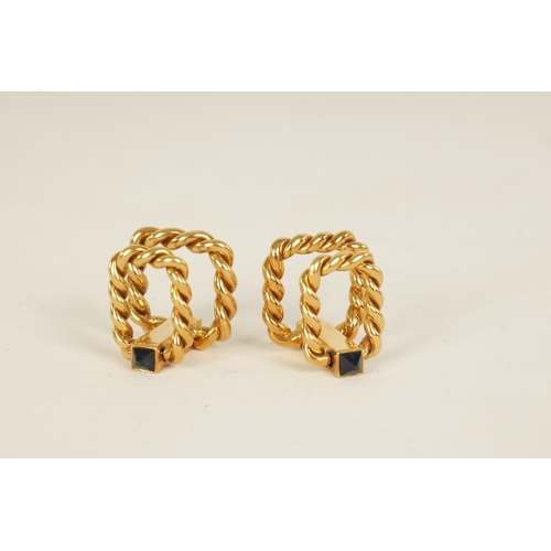 244 - A PAIR OF 18CT GOLD AND SAPPHIRE BOUCHERON CUFFLINKS of hinged rope twist design set with pyramid sa... 