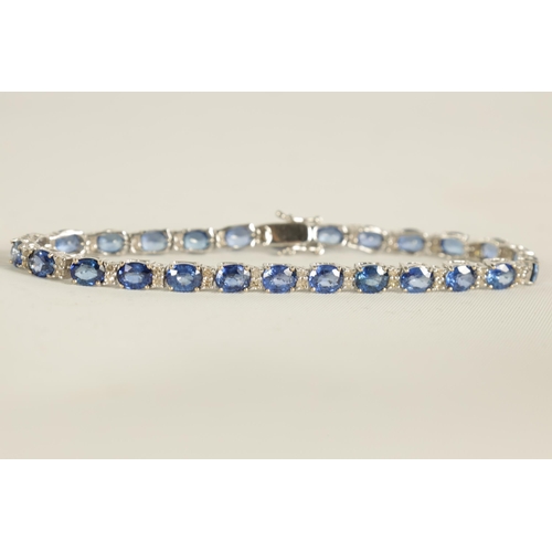 246 - A LADIES 18CT WHITE GOLD DIAMOND AND SAPPHIRE TENNIS BRACELET set with 26 oval-cut sapphires, each l... 