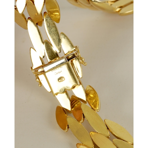 252 - CARTIER. A LADIES 18CT YELLOW GOLD GENTIANE CHOKER NECKLACE the three-row wide articulated choker ne... 