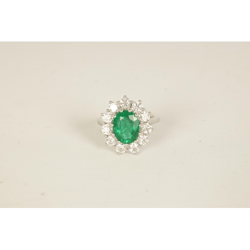 253 - A LARGE 18CT WHITE GOLD EMERALD AND DIAMOND RING set with a 3.31ct oval emerald surrounded by 11 bri... 