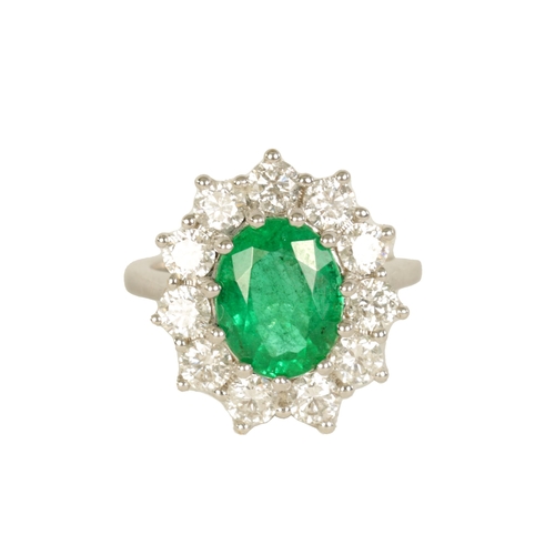 253 - A LARGE 18CT WHITE GOLD EMERALD AND DIAMOND RING set with a 3.31ct oval emerald surrounded by 11 bri... 