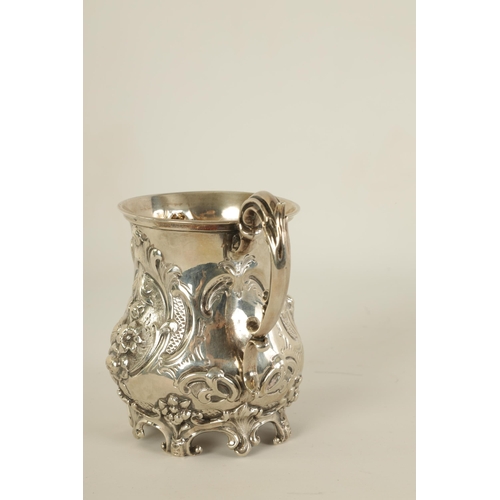 293 - A VICTORIAN SILVER BALUSTER MUG of ornate embossed rococo design with scroll handle and feet - Londo... 