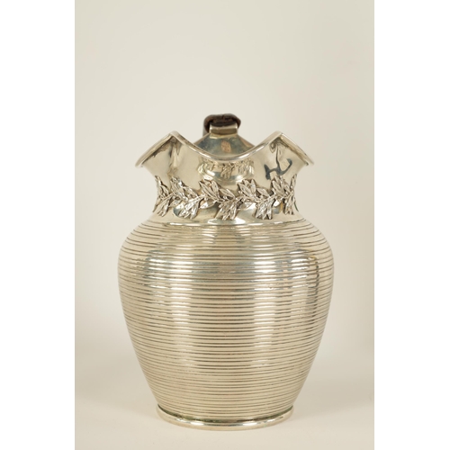 296 - AN EDWARD VII SILVER JUG of squat baluster form with ribbed body, leaf and berry design below the sp... 