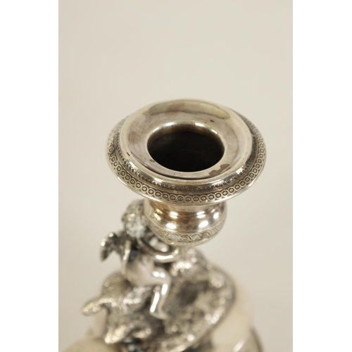 299 - A 19TH CENTURY CONTINENTAL SILVER FIGURAL CANDLESTICK modelled as Cupid riding a goat holding an eng... 
