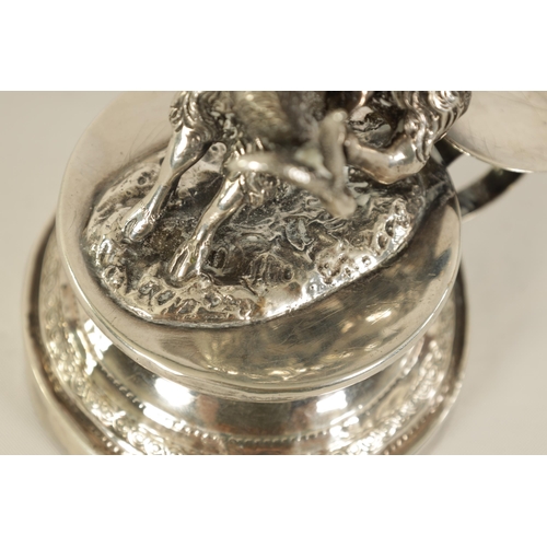 299 - A 19TH CENTURY CONTINENTAL SILVER FIGURAL CANDLESTICK modelled as Cupid riding a goat holding an eng... 