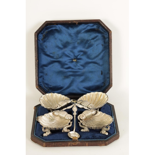 302 - A CASED SET OF FOUR VICTORIAN SILVER ROCOCO STYLE TABLE SALTS formed as shells with dolphin feet and... 